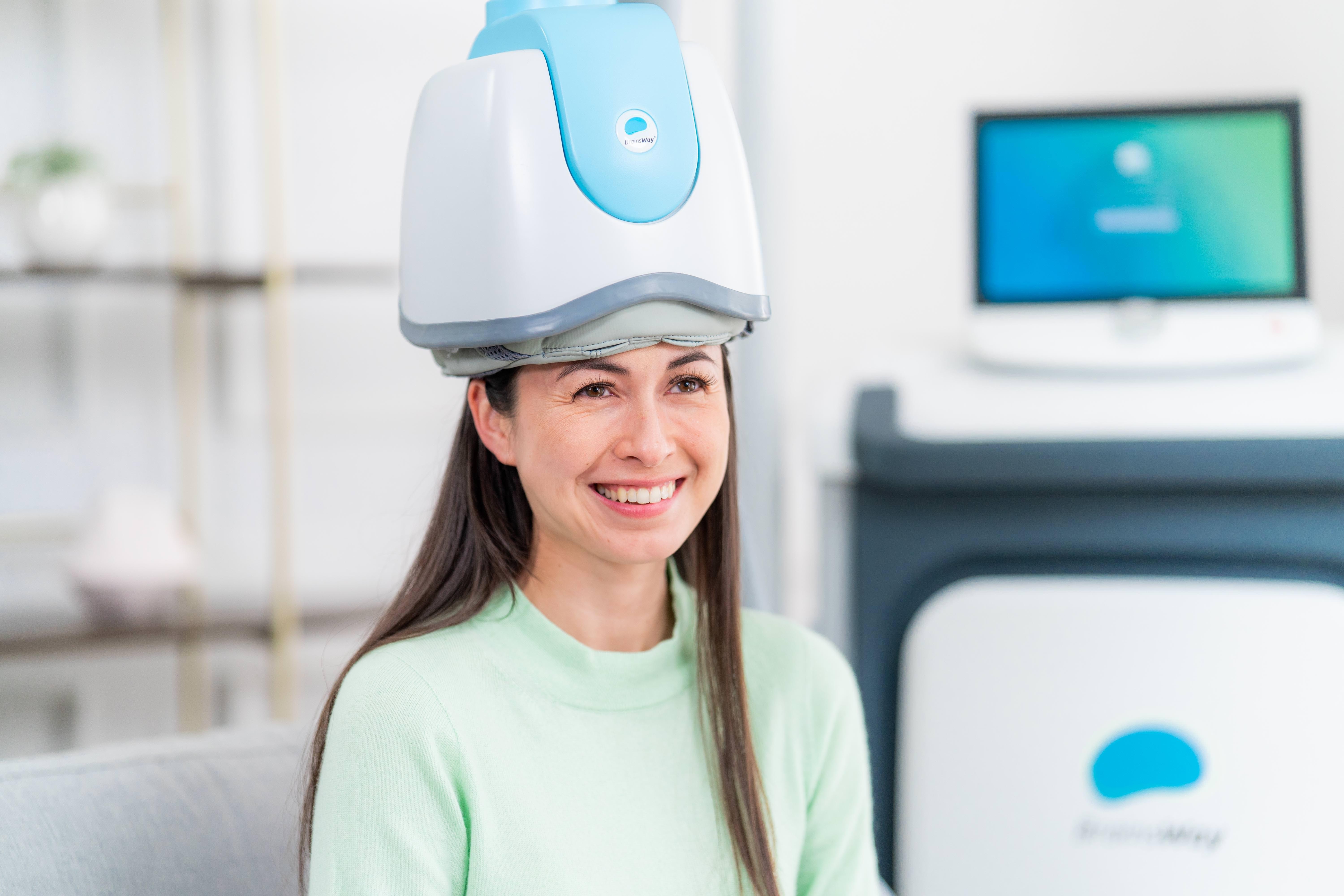 Patient mid-session with the TMS coil in place