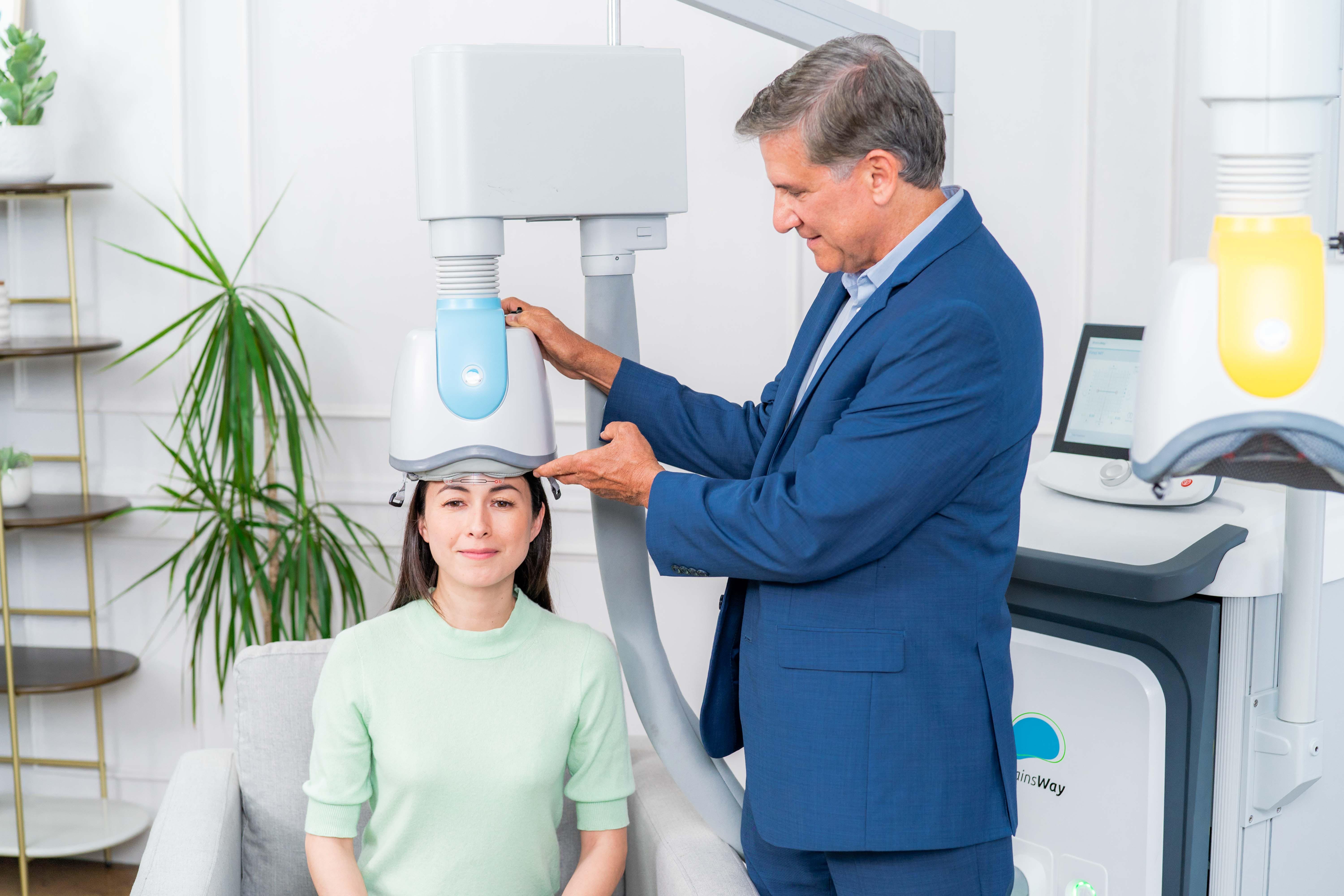 Doctor positioning the TMS coil during brain mapping